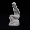 Figurin, sittande kvinna, höjd 24 cm